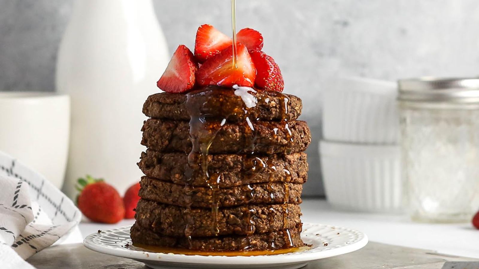 Chocolate Protein Pancakes stacked on each other.