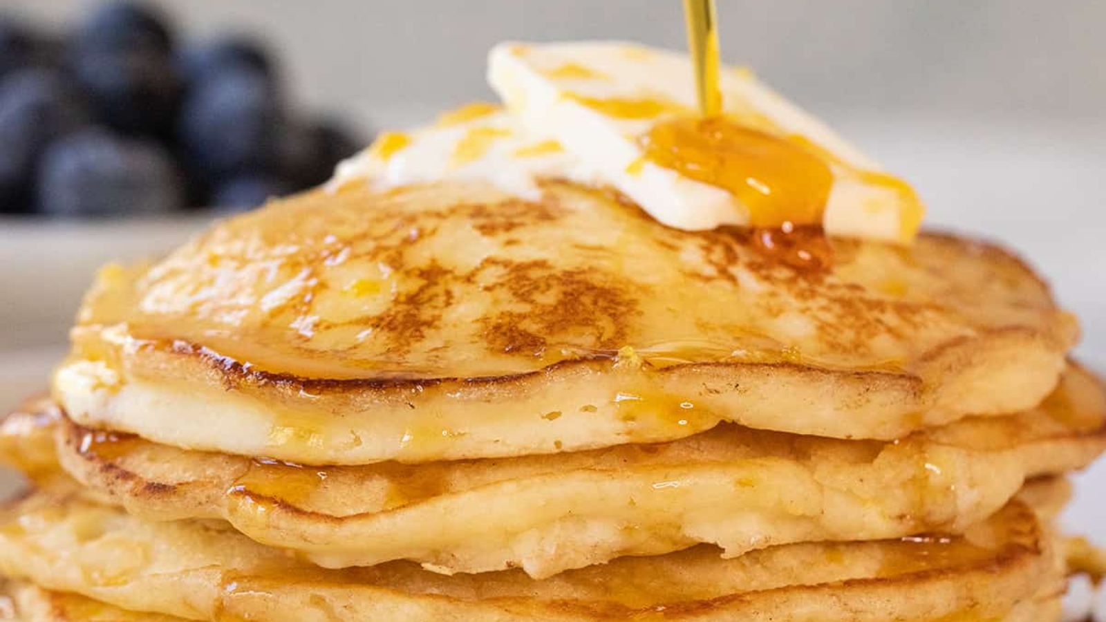 Lemon Ricotta Pancakes stacked on each other with butter on top.