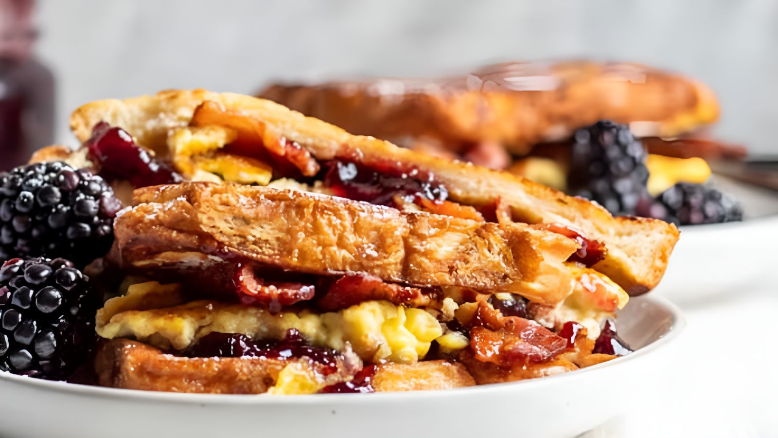 Bacon Blackberry French Toast Sandwiches on a plate.
